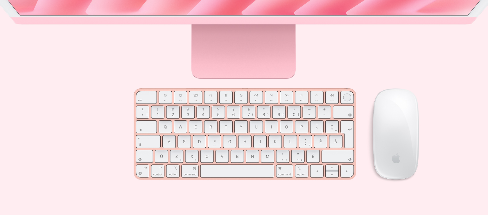 iMac rose vu de haut, avec souris et clavier assortis.