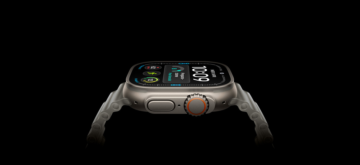 Apple Watch Ultra 4, cassa in titanio naturale, lato destro, Digital Crown, tasto laterale in rilievo, quadrante digitale, cinturino Ocean grigio traslucido