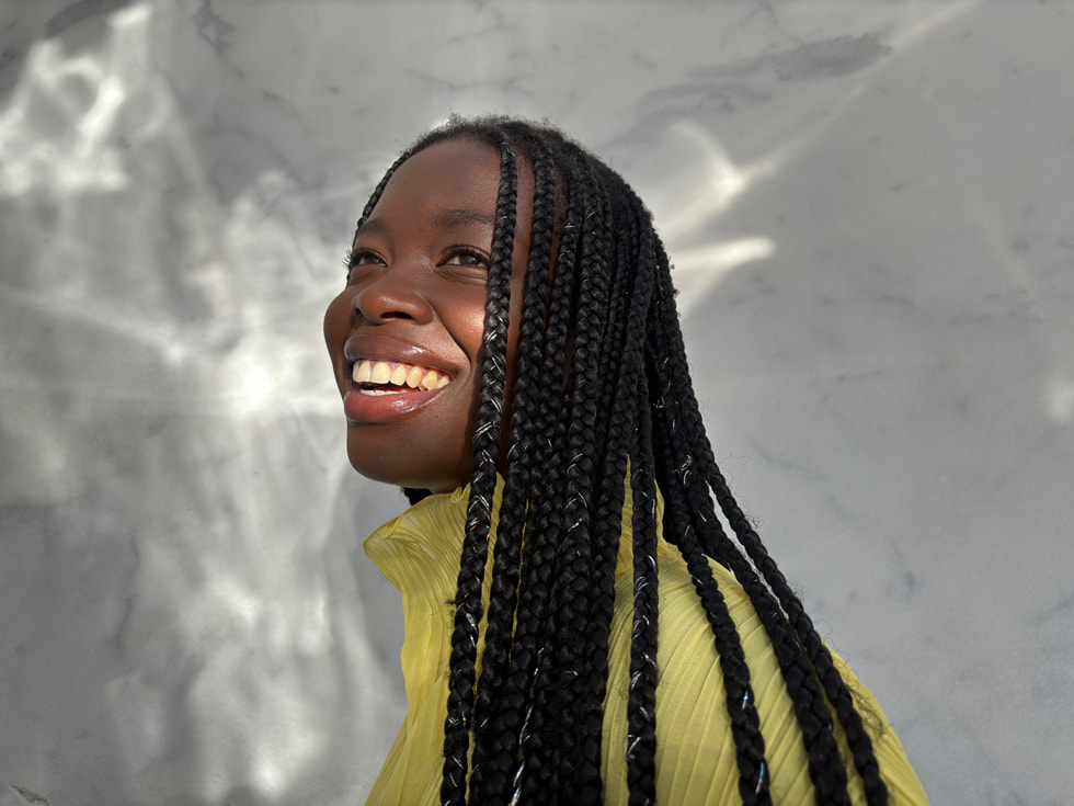 A photo taken on iPhone 15 shows a person smiling.