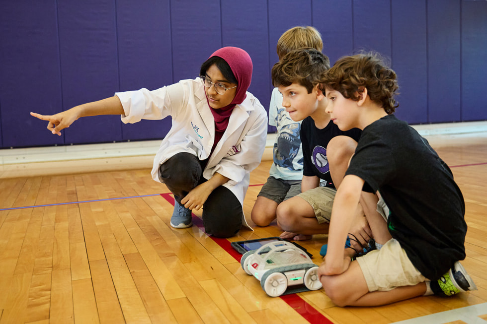 Students set up a robot at the TechConnect event.