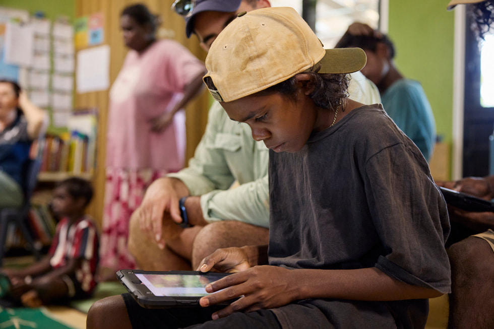 A student from Mamadawerre in Arnhem Land uses iPad in a classroom setting.