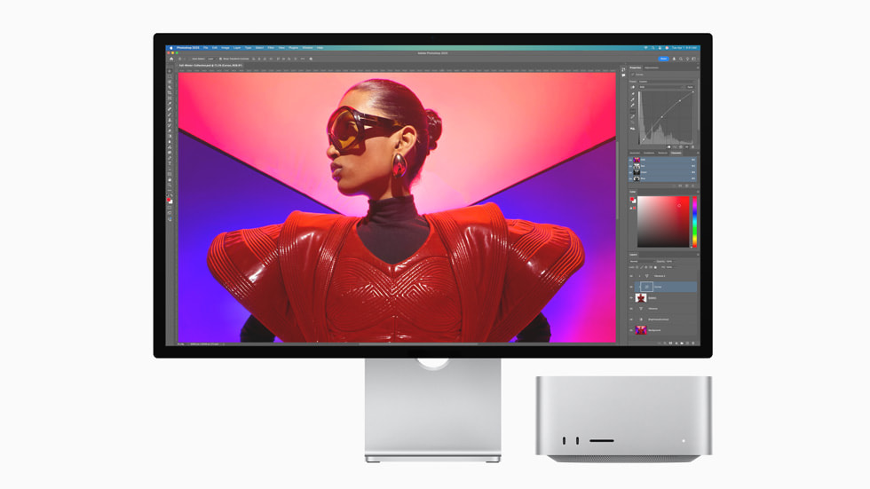 Mac Studio next to a Studio Display showing an Adobe Photoshop project onscreen.