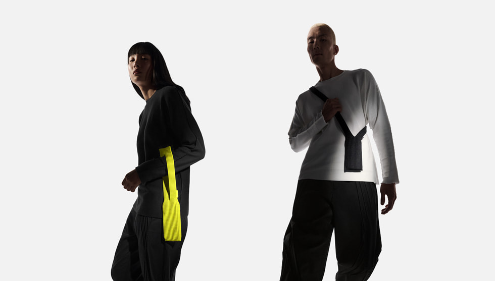 Two users pose with iPhone Pocket in lemon and black.