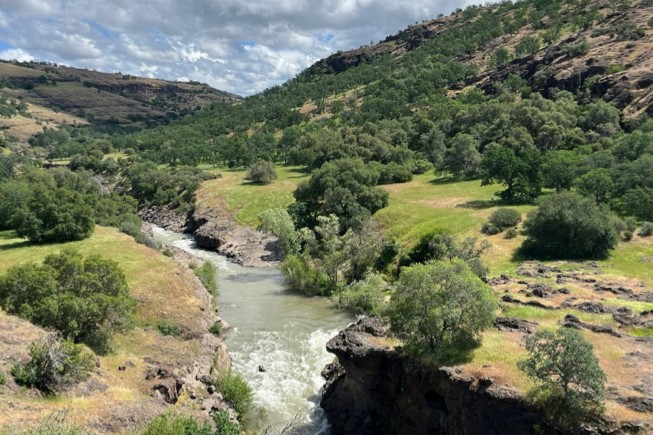 A freshwater creek runs through a valley.