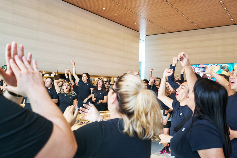 Apple Antara team members and customers inside the store.