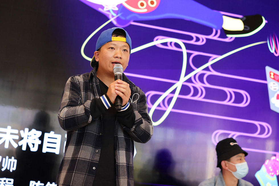 A person performs with a microphone at a Today at Apple Creative Studios session.
