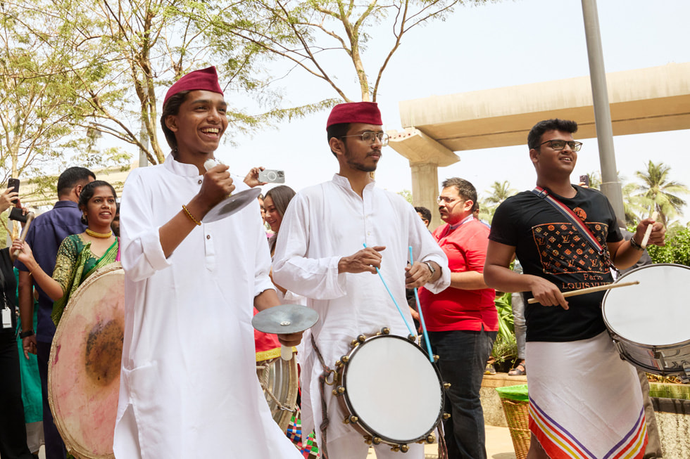 Musicians play instruments outside Apple BKC. 