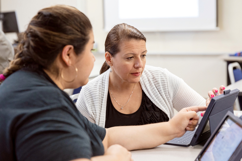 Elementary school teachers working on an app on iPad.