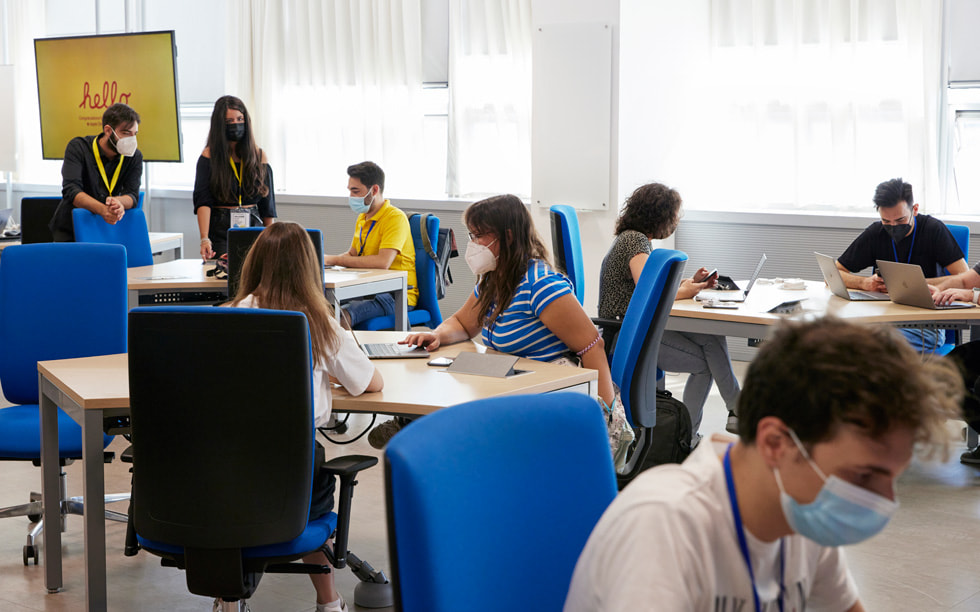 Students work at tables at the Naples Developer Academy.