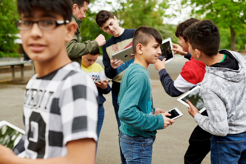 Students with iPads outside.