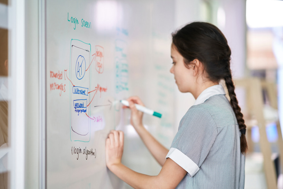 Samantha Cray writes on a whiteboard.