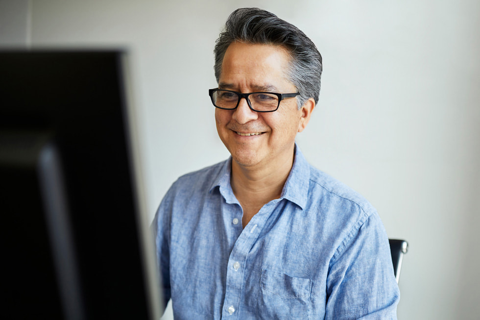 Marcos Gonzalez, founder of VamosVentures, using a computer.