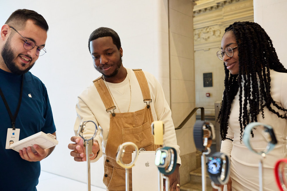An Apple Specialist helping customers on Apple Watch options.
