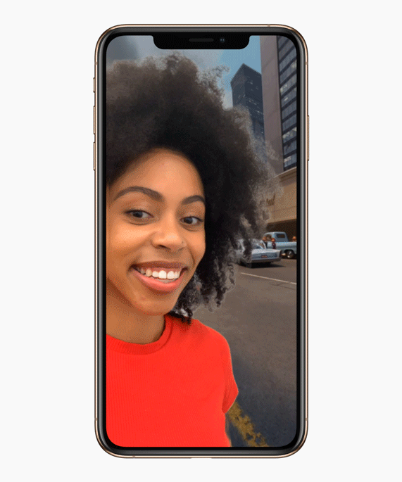 A gif of a woman taking a selfie with the new animated Selfie Scene in Clips.