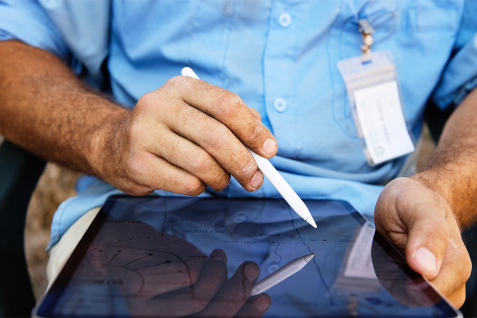 A close-up of Dr. Roger’s hands shows him holding Apple Pencil while sketching on iPad Pro.