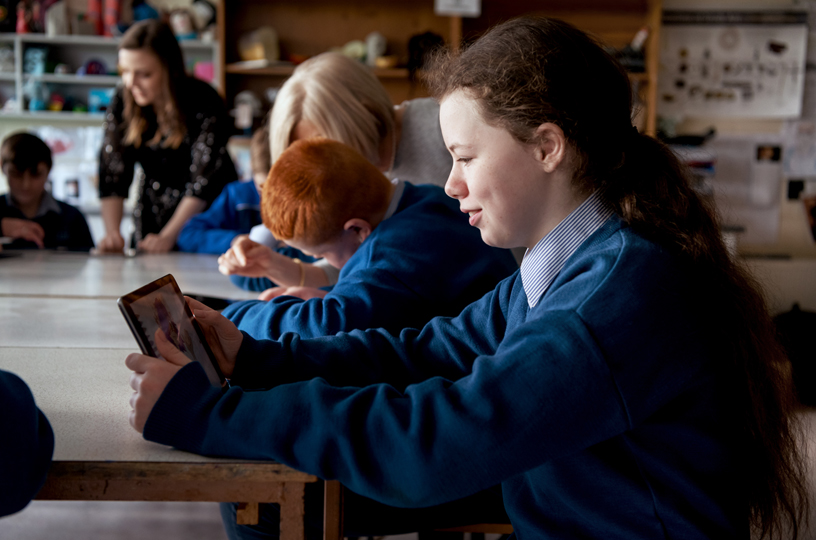 A girl using iPad in the classroom.