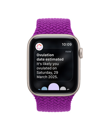 Apple Watch SE 3, screen shows estimated ovulation date, aluminium case, starlight colour, Braided Solo Loop band, magenta colour