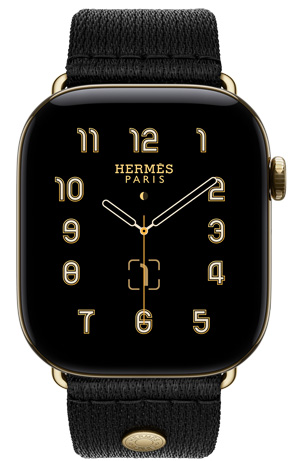 ساعة Apple Watch Hermès Series 12، واجهة الساعة بعقارب Clou de Selle (عقارب الساعة والدقيقة والثانية، الإضافات: الطور القمري، التاريخ)، إطار تيتانيوم، لون ذهبي ساطع، الجهة الخارجية اليمنى، التاج الرقمي، زر جانبي، مقترنة بحزام Satin Clou de Selle بلون Noir، نسيج حريري أسود سلس مع أجزاء بلون ذهبي ساطع تتطابق مع إطار الساعة