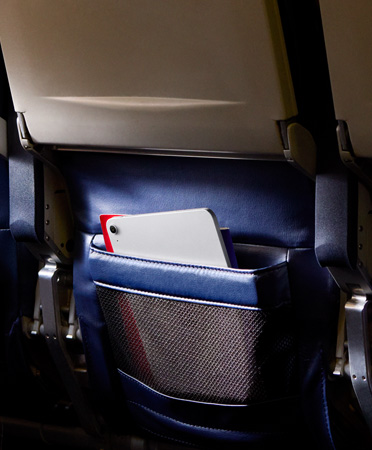 An iPad Air in Silver color left behind in a passenger seatback pocket