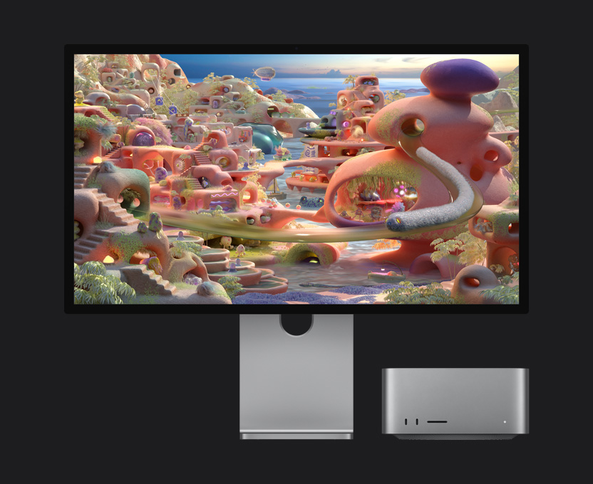 Yanında Mac Studio bulunan bir Studio Display XDR’da bir çizgi film ekranında solucan benzeri bir canlı tüpten çıkıyor ve ekran boyunca ilerliyor