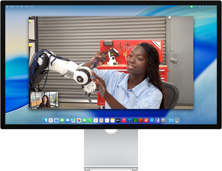 Two people on a video call on Studio Display, Center Stage keeps them centered in the frame even as one person moves to repair a piece of equipment